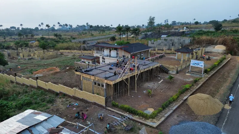 Aerial view of the Kent site during construction, crew working on the roof deck of the main building